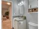 Clean and updated bathroom with concrete countertop vanity and a walk-in shower at 8016 E Fairmount Dr, Denver, CO 80230