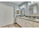 Bright bathroom with double vanity and concrete countertop at 8016 E Fairmount Dr, Denver, CO 80230