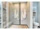Bathroom with glass shower doors and built-in shower seat at 8016 E Fairmount Dr, Denver, CO 80230