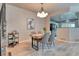 Elegant dining room with a wooden table and modern chandelier at 8016 E Fairmount Dr, Denver, CO 80230