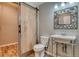 Modern bathroom with barn door and updated vanity at 8016 E Fairmount Dr, Denver, CO 80230