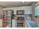 Stainless steel appliances and granite countertops highlight this updated kitchen at 8016 E Fairmount Dr, Denver, CO 80230