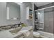 Modern bathroom with a concrete sink, glass shower, and updated fixtures at 8016 E Fairmount Dr, Denver, CO 80230