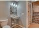 Updated bathroom with a pedestal sink and stylish mirror at 8016 E Fairmount Dr, Denver, CO 80230