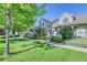 Two-story townhome with brick and siding exterior, landscaping, and walkway at 8016 E Fairmount Dr, Denver, CO 80230