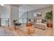 Open concept living room featuring a sectional sofa and contemporary decor at 8016 E Fairmount Dr, Denver, CO 80230
