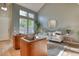 Spacious living room with large windows, hardwood floors and modern furniture at 8016 E Fairmount Dr, Denver, CO 80230