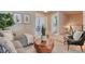Bright living room with comfy seating, stylish decor, and hardwood floors at 8016 E Fairmount Dr, Denver, CO 80230