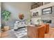 Light-filled living room featuring a modern fireplace and hardwood floors at 8016 E Fairmount Dr, Denver, CO 80230