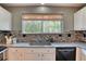 Modern kitchen sink and dishwasher with stylish backsplash at 8016 E Fairmount Dr, Denver, CO 80230