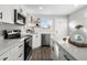 Modern kitchen with white cabinets, stainless steel appliances, and a corner sink at 800 Meade St, Denver, CO 80204