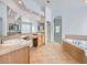 Elegant bathroom featuring a large vanity and garden tub at 7447 Soapstone Way, Castle Rock, CO 80108