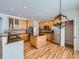 Modern kitchen with wood cabinets, granite countertops and island at 7447 Soapstone Way, Castle Rock, CO 80108