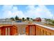 View from the front steps showing a gravel yard and street at 3040 W 66Th Ave, Denver, CO 80221
