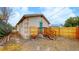 Backyard with gravel, wooden fence, and small deck at 3040 W 66Th Ave, Denver, CO 80221