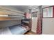 Small bedroom with a bunk bed and geometric curtains at 3040 W 66Th Ave, Denver, CO 80221