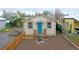 Newly remodeled bungalow with teal door and wood fence at 3040 W 66Th Ave, Denver, CO 80221