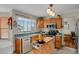 Kitchen with oak cabinets, a center island, and stainless steel appliances at 21806 Saddlebrook, Parker, CO 80138