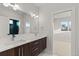 Dual vanity bathroom with dark wood cabinets and modern fixtures at 2468 S Cherokee St, Denver, CO 80223