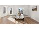 Dining area with glass table and white chairs near kitchen at 2468 S Cherokee St, Denver, CO 80223