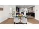 Dining area with glass table, white chairs, and view of the kitchen at 2468 S Cherokee St, Denver, CO 80223