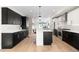 Modern kitchen with dark cabinetry and center island at 2468 S Cherokee St, Denver, CO 80223