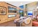 Relaxing living room with stone fireplace and large windows offering scenic views at 7793 Elk Path Way, Morrison, CO 80465
