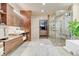 Spa-like bathroom with walk-in shower, soaking tub, and modern finishes at 7793 Elk Path Way, Morrison, CO 80465