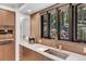 Modern kitchen with farmhouse sink and wooded views at 7793 Elk Path Way, Morrison, CO 80465