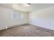 Well-lit bedroom featuring neutral wall paint and carpet at 2565 S Sheridan Blvd # 20, Denver, CO 80227