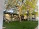 Apartment building with a grassy courtyard and mature trees at 2565 S Sheridan Blvd # 20, Denver, CO 80227