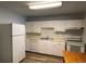 Kitchen features white cabinets, dishwasher, and an electric stove at 2565 S Sheridan Blvd # 20, Denver, CO 80227