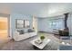 Bright living room features a fireplace and is furnished with a sofa and coffee table at 2565 S Sheridan Blvd # 20, Denver, CO 80227