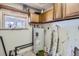 Laundry room with water heater and upper cabinets at 801 Panorama Dr, Golden, CO 80401