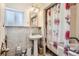 Bathroom with pedestal sink, bathtub, and shower curtain at 801 Panorama Dr, Golden, CO 80401