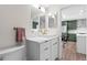 Updated bathroom with white vanity, marble countertops, and gold fixtures at 13750 W 65Th Ave, Arvada, CO 80004