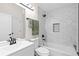 Updated bathroom features a hexagon-tile shower, white vanity, and bathtub at 13750 W 65Th Ave, Arvada, CO 80004