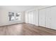 Large bedroom with double closets and wood-look flooring at 13750 W 65Th Ave, Arvada, CO 80004