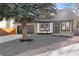 Two-story house with dark gray garage doors and a stone front yard at 13750 W 65Th Ave, Arvada, CO 80004