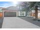 Charming two-story home with a gray driveway and landscaped yard at 13750 W 65Th Ave, Arvada, CO 80004
