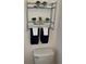 Clean bathroom with a toilet, shelving, and towels at 3092 S Yarnell Ct, Denver, CO 80231