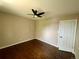 Simple bedroom with ceiling fan, hardwood floors, and an access door at 3092 S Yarnell Ct, Denver, CO 80231