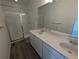 Bathroom with double vanity, shower, and gray flooring at 8481 Eagle River St, Littleton, CO 80125