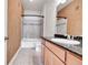 Clean bathroom with a tub, shower, and granite countertop at 301 Inverness Way # 209, Englewood, CO 80112