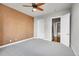 Spacious bedroom with ceiling fan and access to bathroom at 301 Inverness Way # 209, Englewood, CO 80112