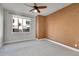 Bright bedroom with ceiling fan and neutral carpeting at 301 Inverness Way # 209, Englewood, CO 80112