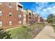 Brick building exterior with landscaping and walkway at 301 Inverness Way # 209, Englewood, CO 80112