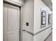 Apartment hallway with door to unit 209 and wall art at 301 Inverness Way # 209, Englewood, CO 80112