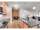 Open concept kitchen with an island and hardwood floors at 301 Inverness Way # 209, Englewood, CO 80112
