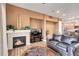 Cozy living room featuring a fireplace and a view into the kitchen at 301 Inverness Way # 209, Englewood, CO 80112